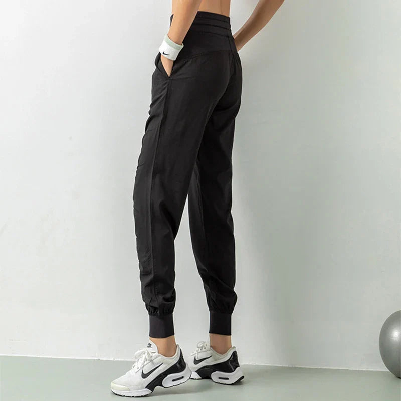 Premium women's sports trousers with drawstring waist and pockets, made of high-quality nylon fabric for comfort and versatility.