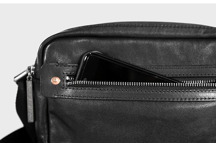 A premium British leather shoulder bag with a sleek, minimalist design and adjustable strap