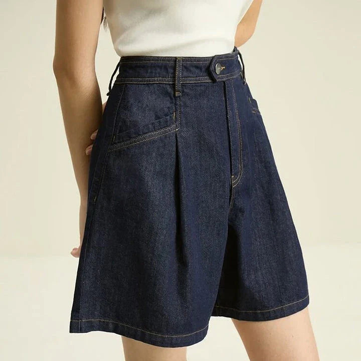 Dark denim high-waist loose shorts with retro pleated design, offering comfort and style for the modern British woman.