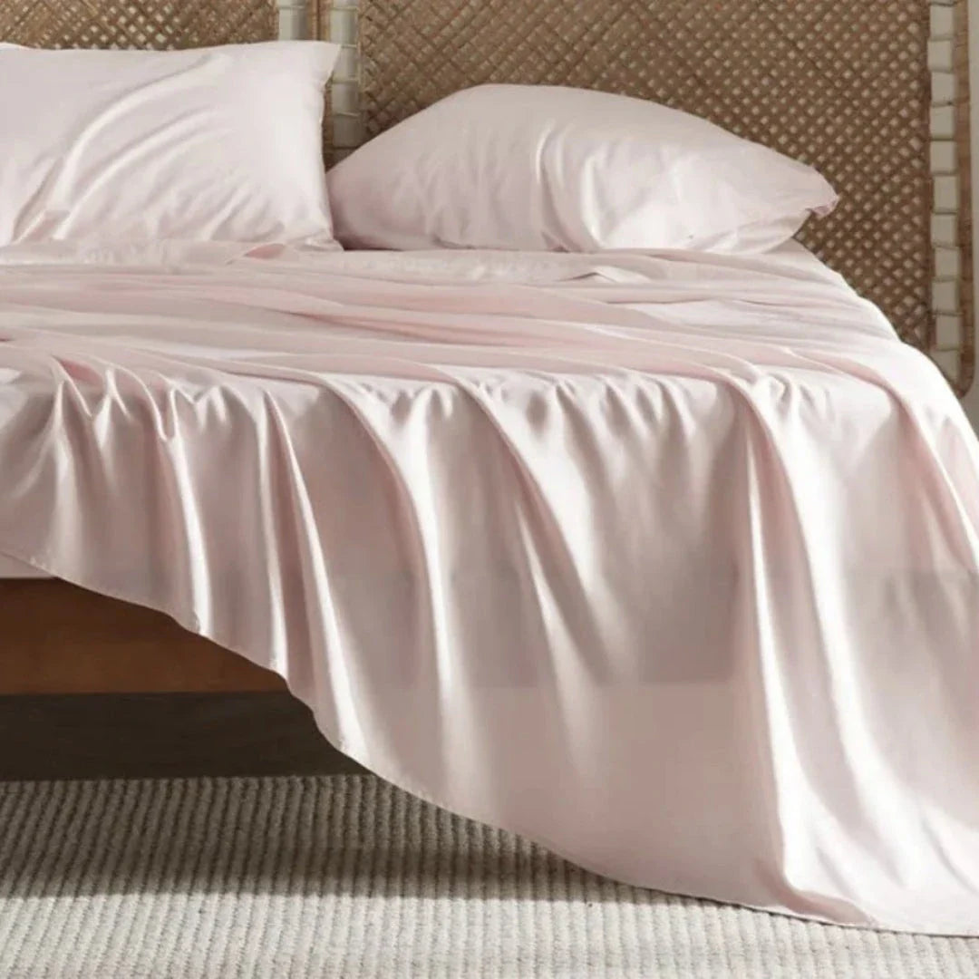 Premium bamboo fibre bed sheets in a classic solid purplish blue colour, featuring a four-piece set including a fitted sheet, flat sheet, and two pillowcases.