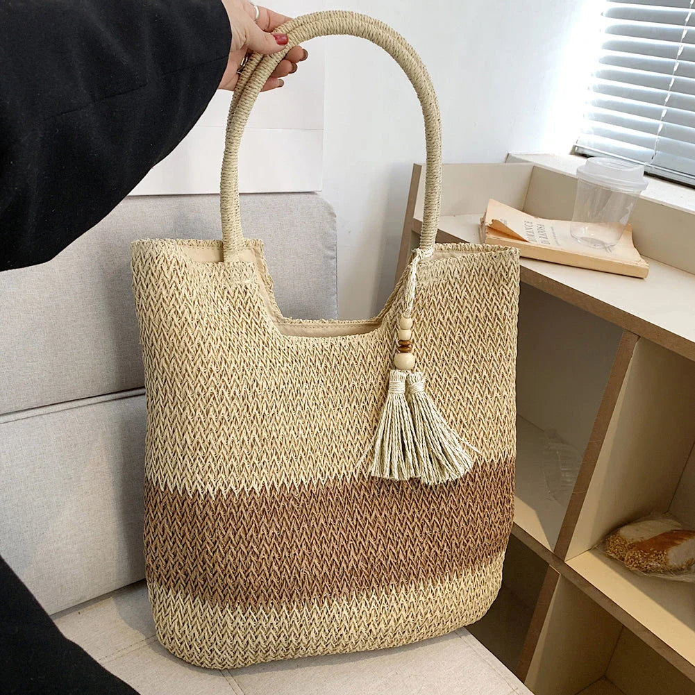 Stylish bohemian-inspired woven tote bag with contrasting tassels, perfect for summer outings