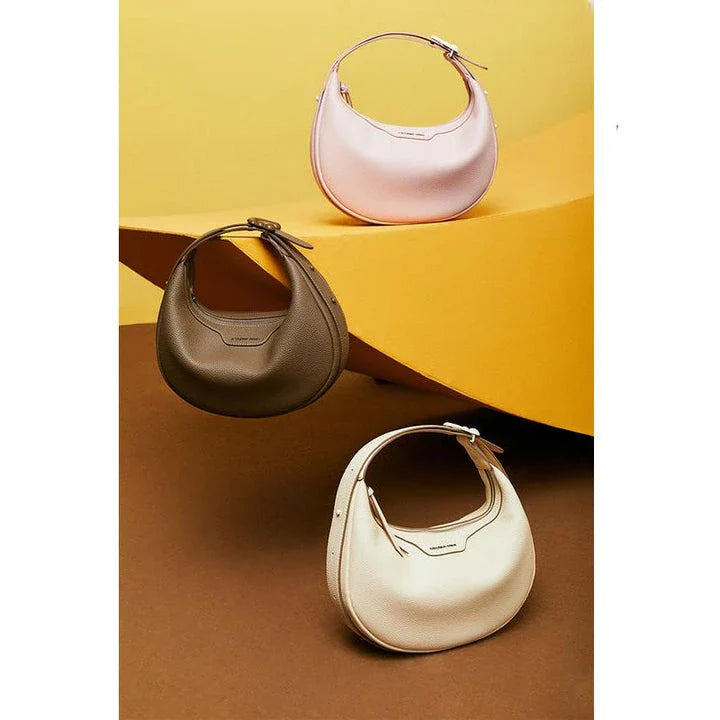 Stylish crescent-shaped leather crossbody bag with soft, supple texture for everyday elegance