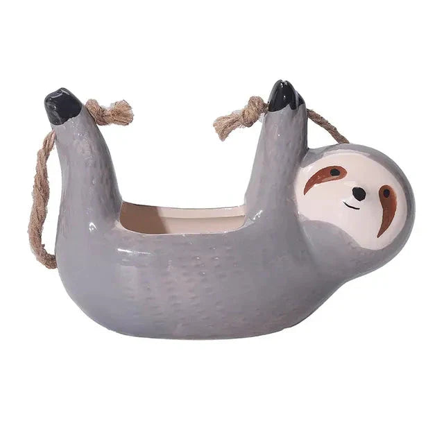 Ceramic hanging planter with a whimsical cartoon animal design, available in grey or yellow, for adding a touch of nature and playfulness to indoor spaces.