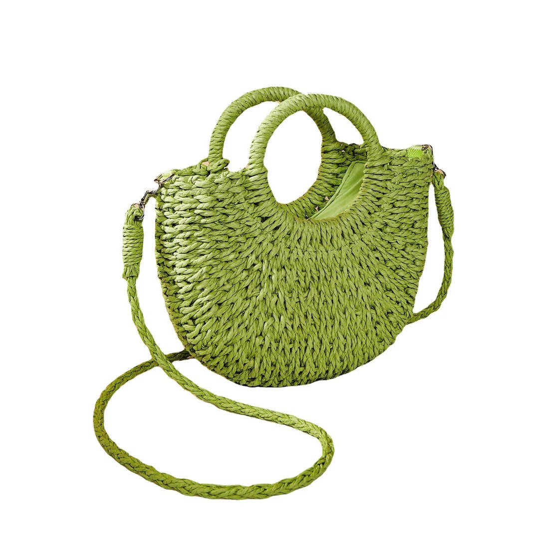 Stylish straw woven women's beach shoulder bag in a half-moon shape, featuring a cotton lining and string closure for a minimalist, bohemian-inspired look.