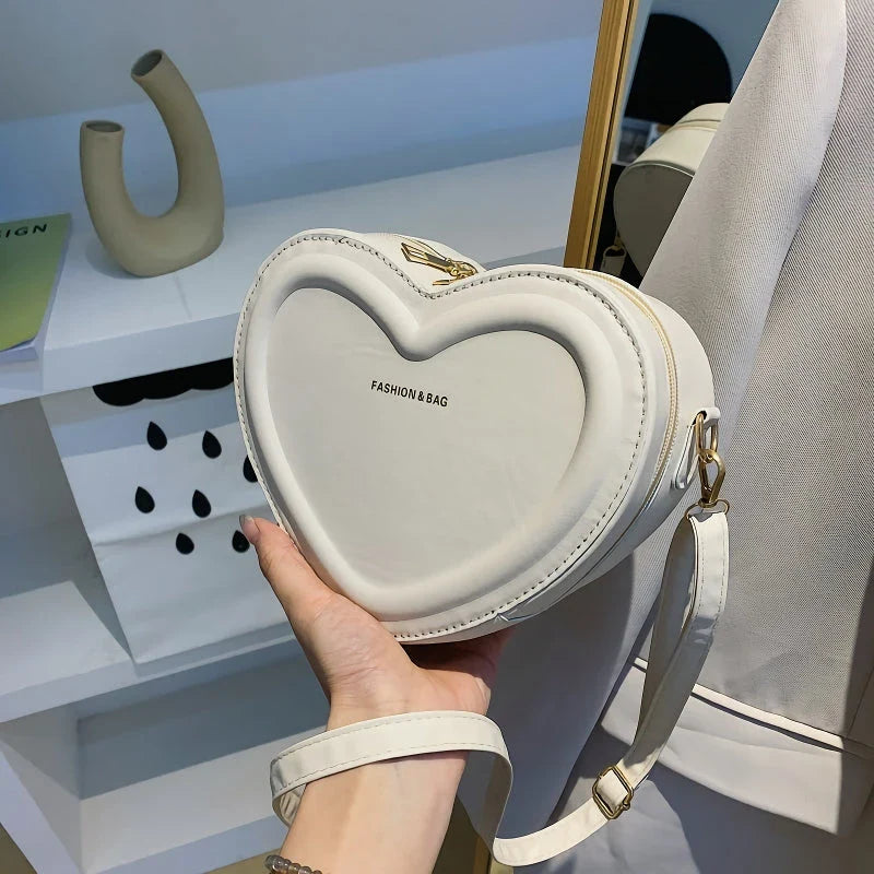 Chic heart-shaped crossbody bag made from premium PU leather, available in multiple stylish colours