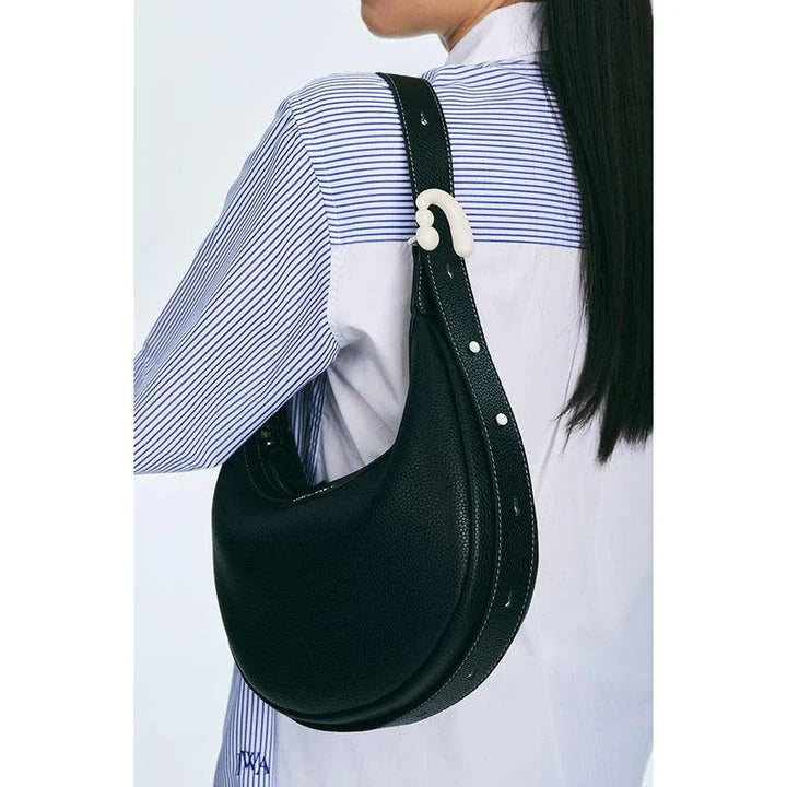 Stylish crescent-shaped leather crossbody bag with soft, supple texture for everyday elegance