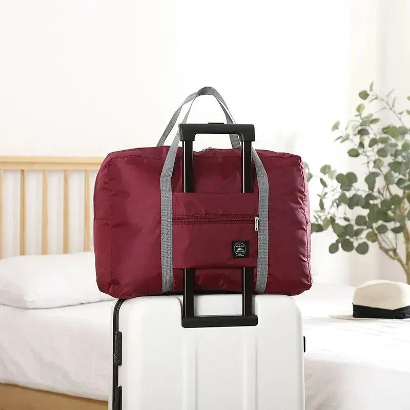 Premium foldable travel duffel bag in a solid colour design, with a large capacity and lightweight construction for women's travel needs.