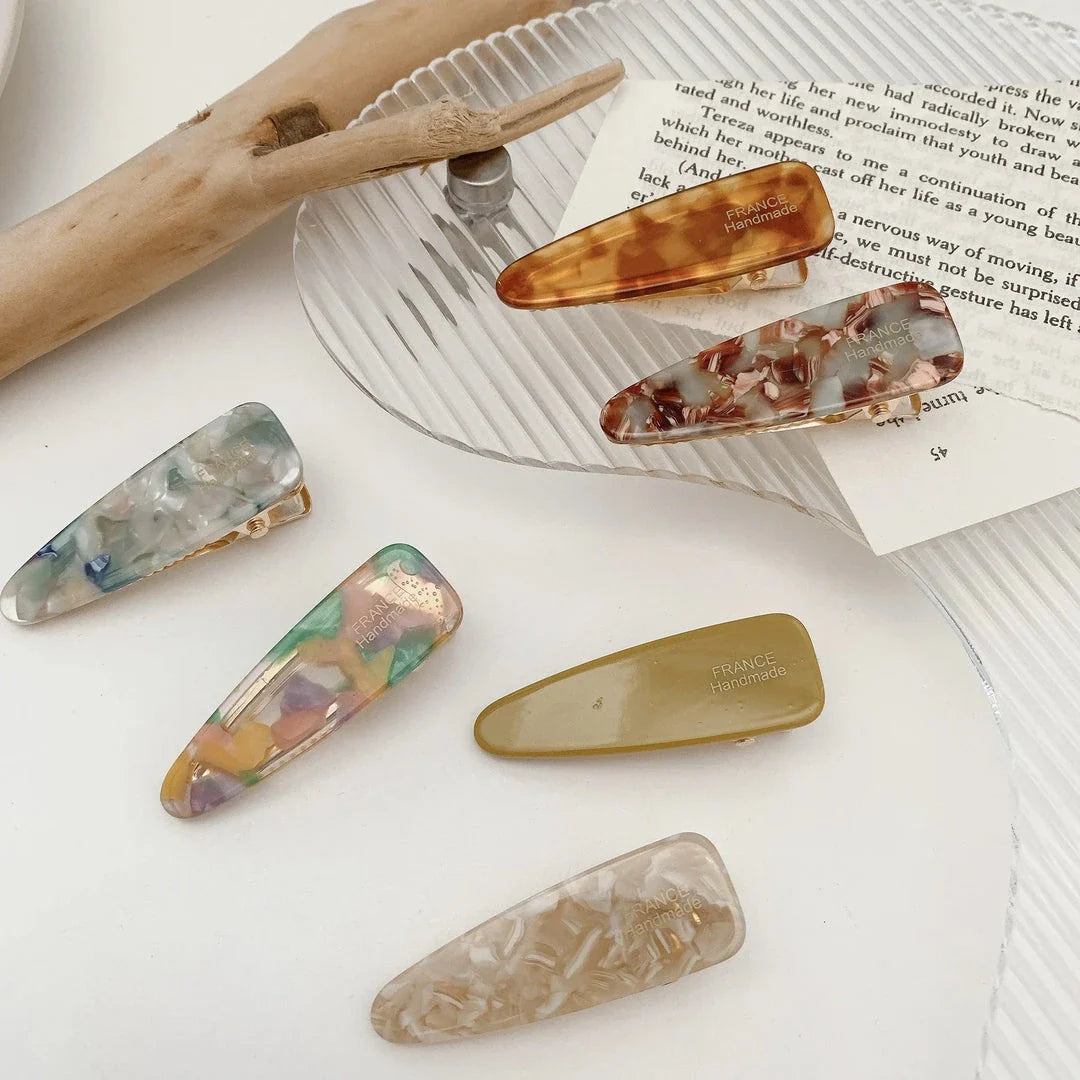 Two marble-patterned hair clips in a contemporary geometric design, made from high-quality acetate and acrylic materials.