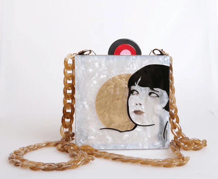 Antique hand-stitched acrylic crossbody bag in a vintage style with a yellow chain strap, perfect for evening events or everyday use.