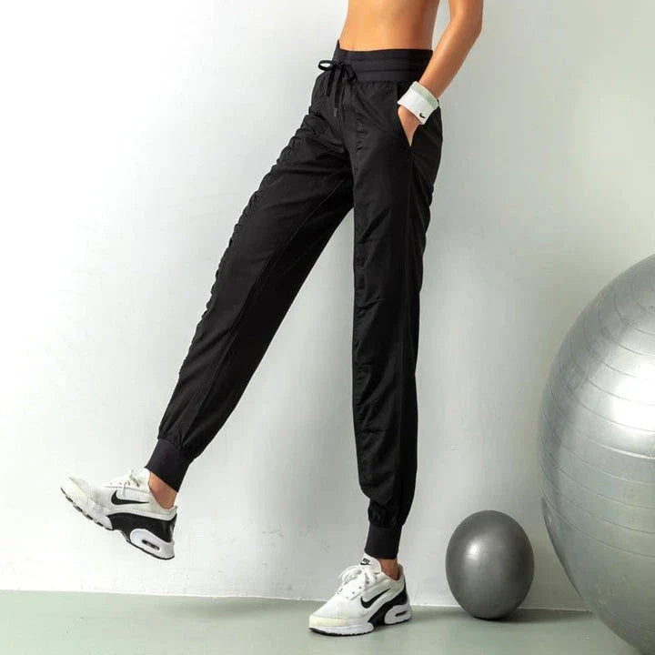 Premium women's sports trousers with drawstring waist and pockets, made of high-quality nylon fabric for comfort and versatility.