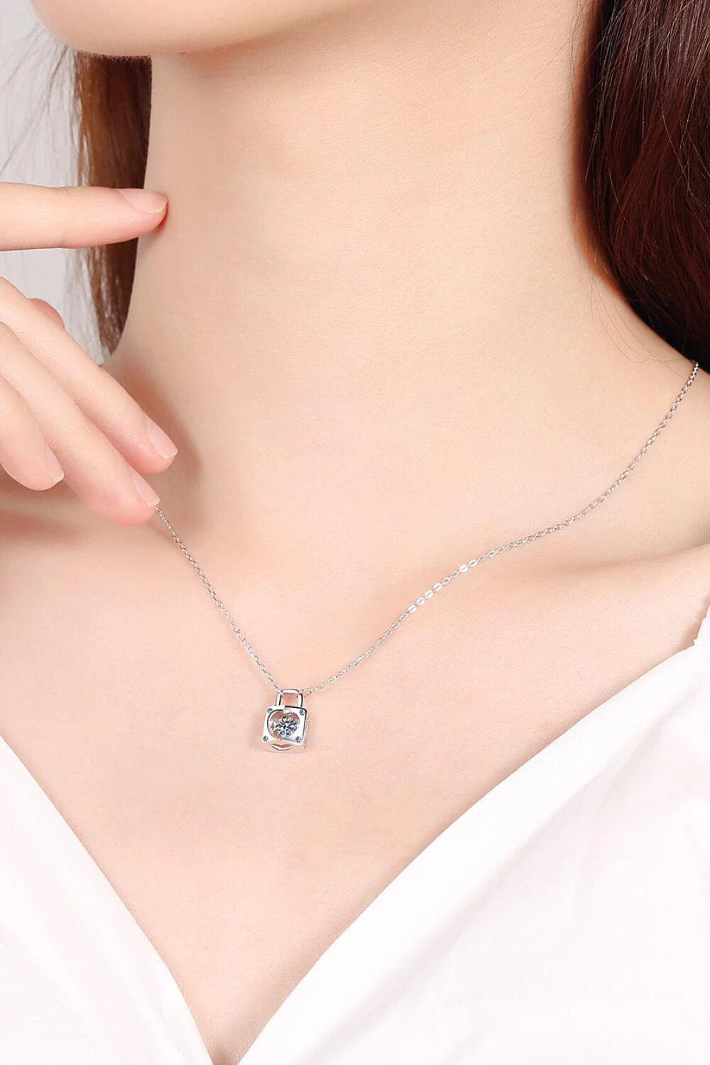 Elegant sterling silver moissanite lock pendant necklace with a minimalist, modern design