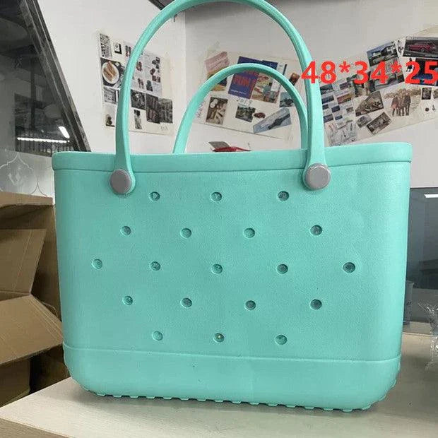 Premium waterproof beach tote bag in various vibrant colours, featuring spacious main compartment and multiple pockets for organised storage