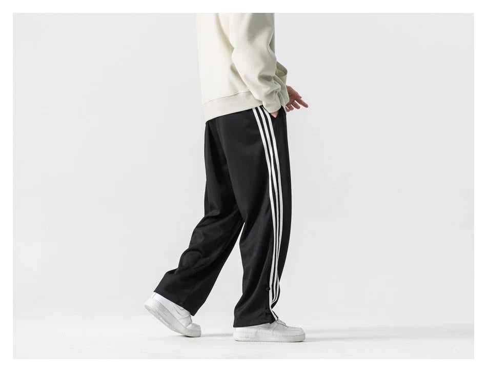 Stylish striped sports trousers in a relaxed, mid-waist design for versatile leisure and athletic wear