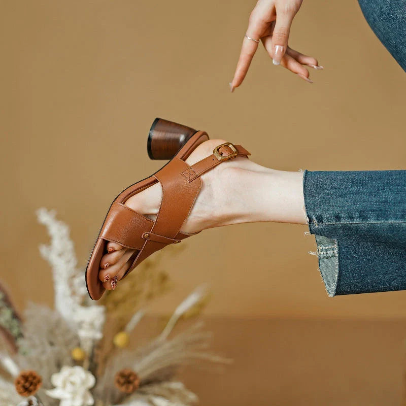 Elegant leather high heel sandals for women, featuring a refined square heel, stylish buckle strap, and sleek design for a sophisticated look.