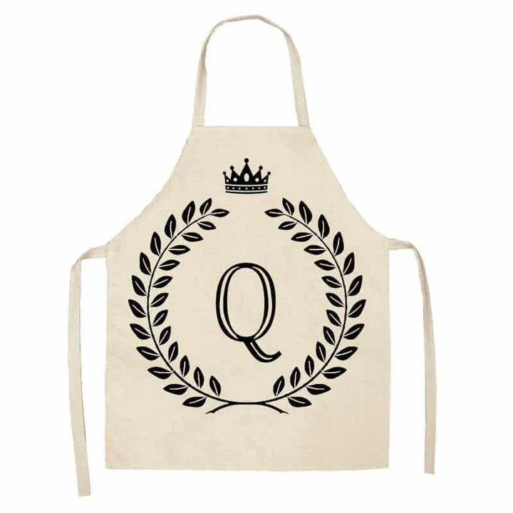 A high-quality kitchen apron featuring a charming crown and letter print design in a premium cotton and linen blend fabric.