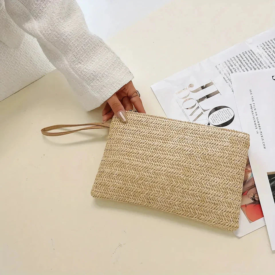 A natural straw-woven clutch with a zipper closure, perfect for summer outings in the UK.