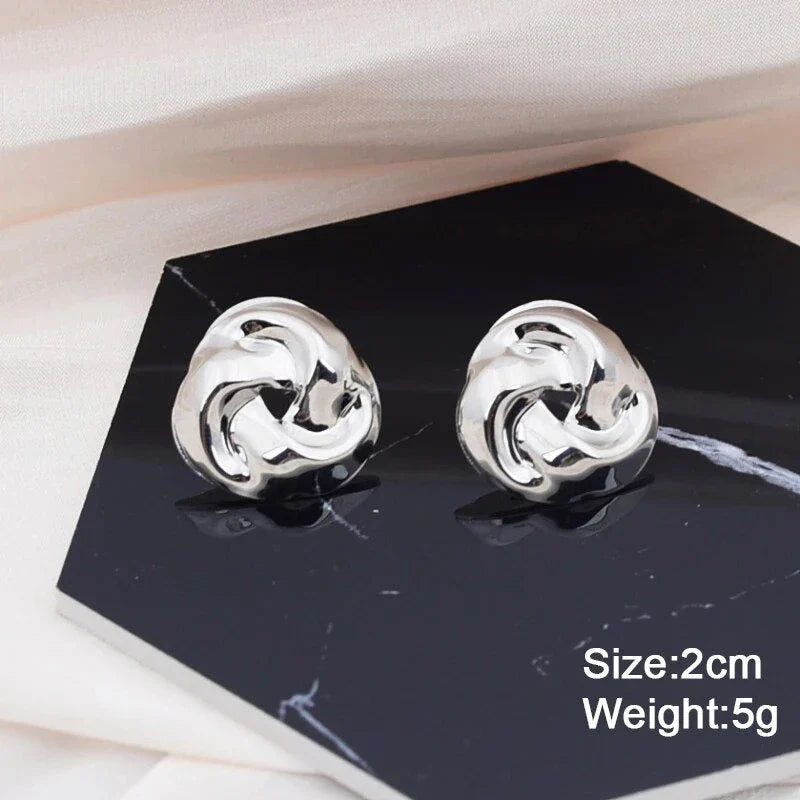 Pair of gold spiral drop earrings with an exaggerated, dramatic design for a bold, fashionable look