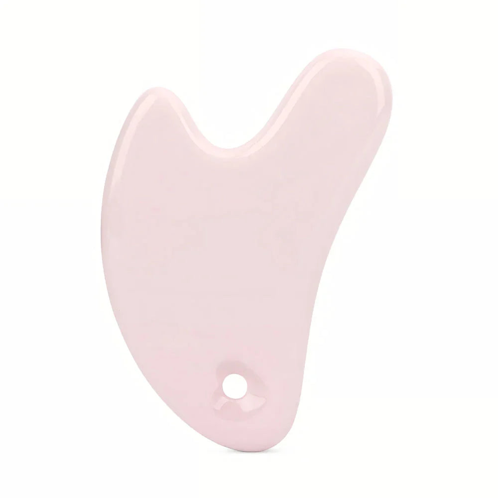 Ceramic Gua Sha facial massager in blue, pink, and white colours, designed to improve circulation and promote lymphatic drainage for radiant, youthful skin.