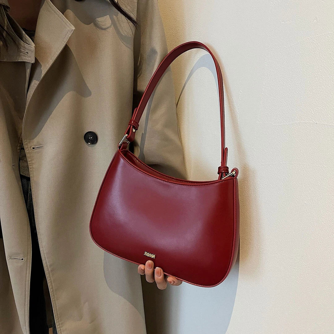 Luxury red leather crossbody bag with sleek design and elegant details