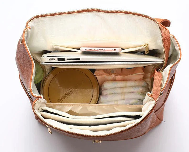 A stylish and practical PU leather mummy bag with a large capacity, multiple pockets, and included accessories like a changing pad and stroller hooks.