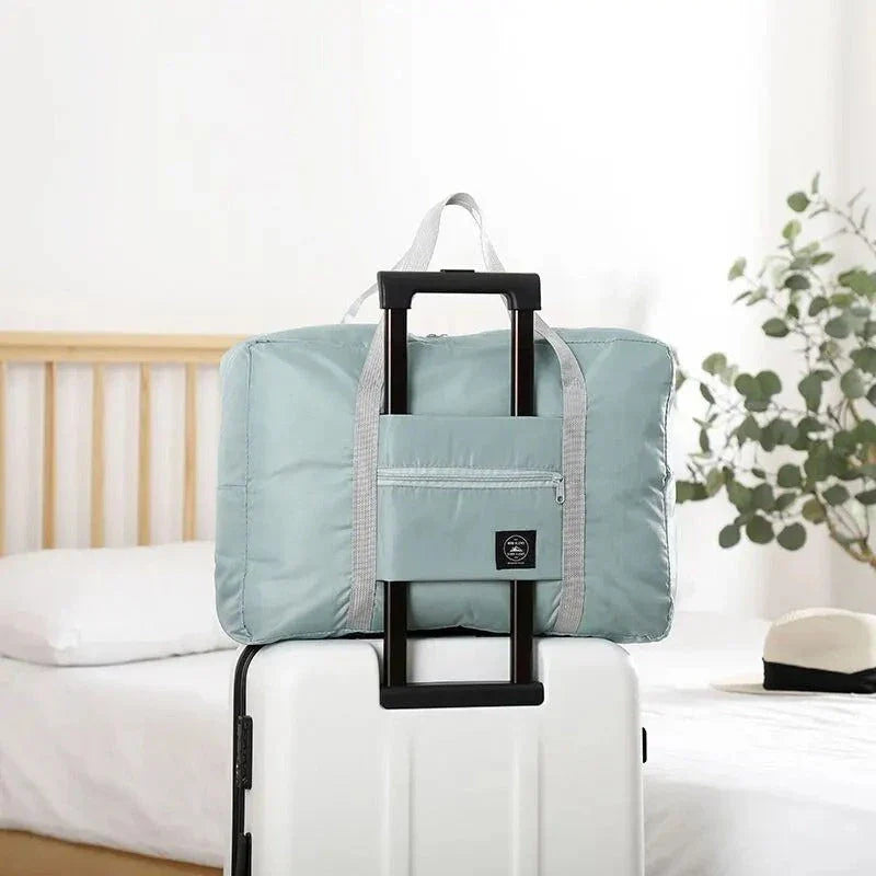 Premium foldable travel duffel bag in a solid colour design, with a large capacity and lightweight construction for women's travel needs.