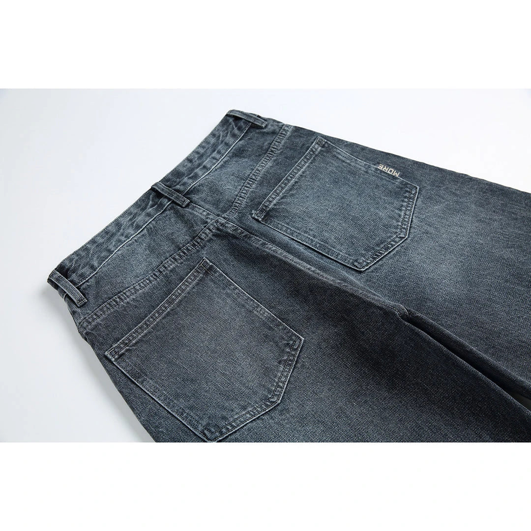 A pair of stylish retro-inspired Japanese jeans in black and grey, featuring a mid-rise waist and straight leg silhouette for a flattering, comfortable fit.