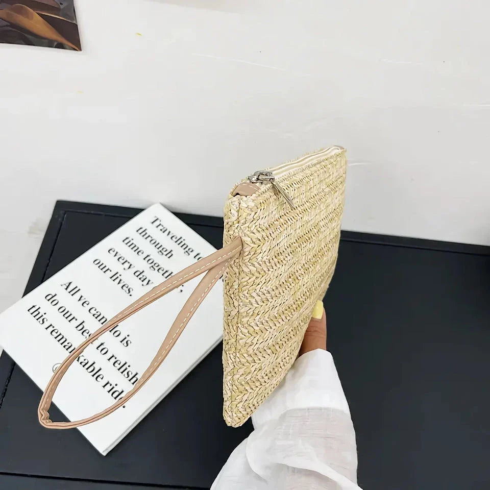 A natural straw-woven clutch with a zipper closure, perfect for summer outings in the UK.