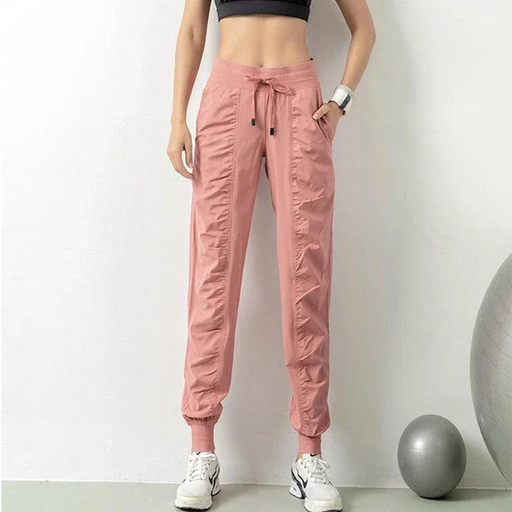 Premium women's sports trousers with drawstring waist and pockets, made of high-quality nylon fabric for comfort and versatility.