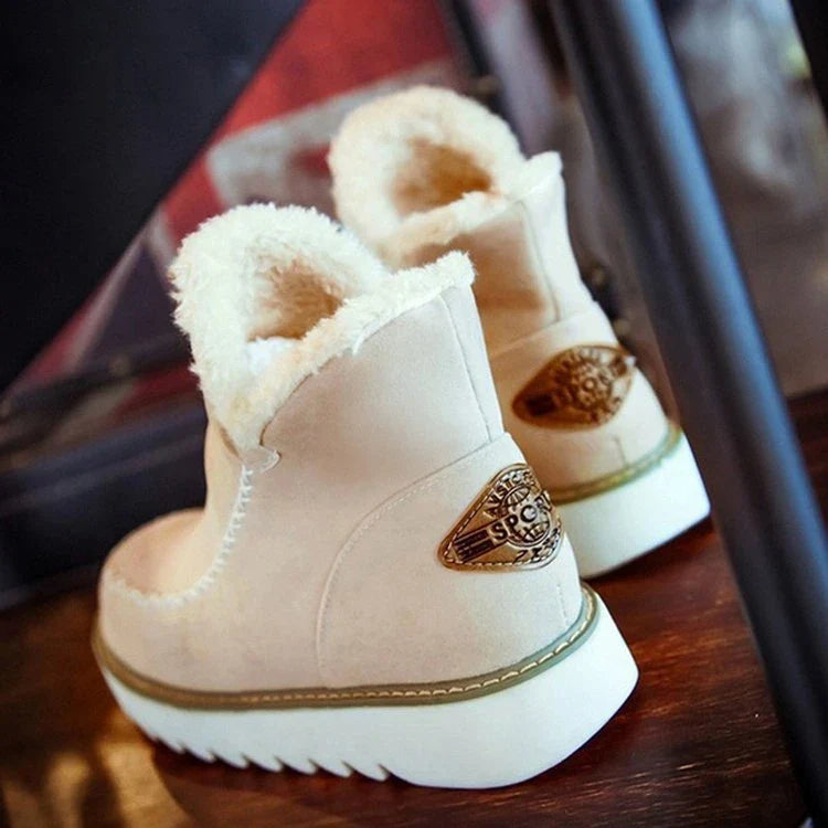 A pair of stylish, non-slip snow boots with a warm artificial wool lining, perfect for British winter weather