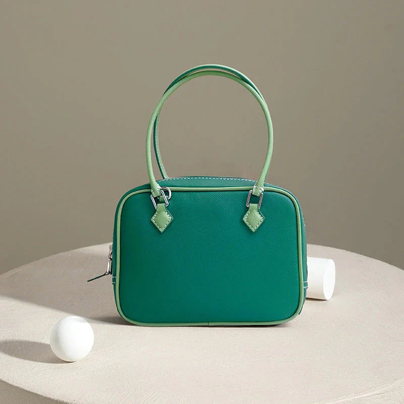 Elegant leather mini shoulder bag in a variety of colours, featuring a compact and versatile design for the stylish British woman.