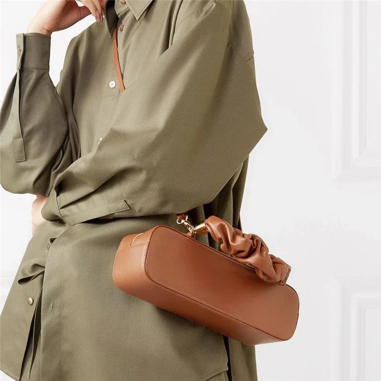Sophisticated long shoulder diagonal bag with a sleek horizontal square design, made of durable synthetic leather and featuring a single shoulder strap for hands-free convenience.