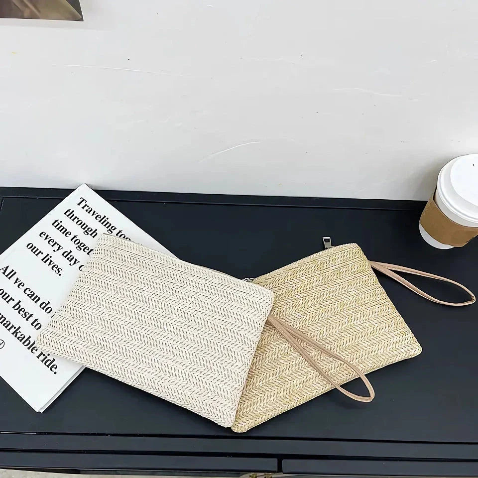 A natural straw-woven clutch with a zipper closure, perfect for summer outings in the UK.