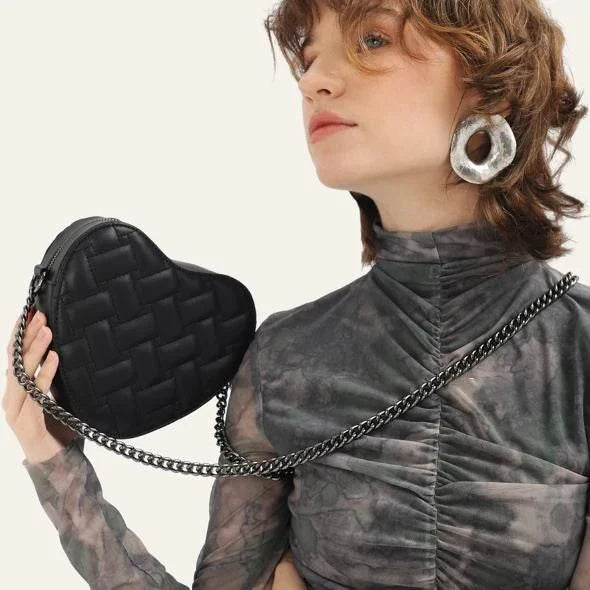 A stylish heart-shaped vegan leather crossbody bag with colourful rhinestone detailing, a versatile and fashionable accessory.