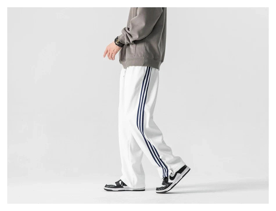 Stylish striped sports trousers in a relaxed, mid-waist design for versatile leisure and athletic wear