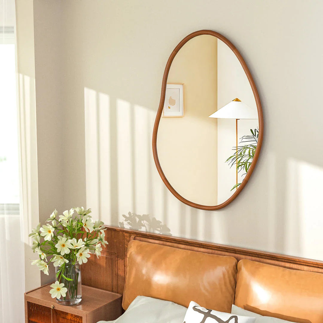 Stylish mid-century asymmetric decorative wall mirror with solid beech wood frame, adding visual interest and reflecting light to create a brighter, more open living space.