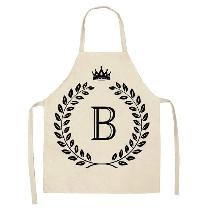 A high-quality kitchen apron featuring a charming crown and letter print design in a premium cotton and linen blend fabric.