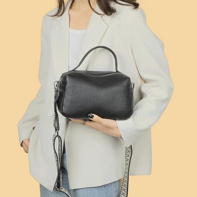 Luxurious genuine leather crossbody bag for women, featuring a soft polyester lining, dual phone pockets, and a compact, square design.