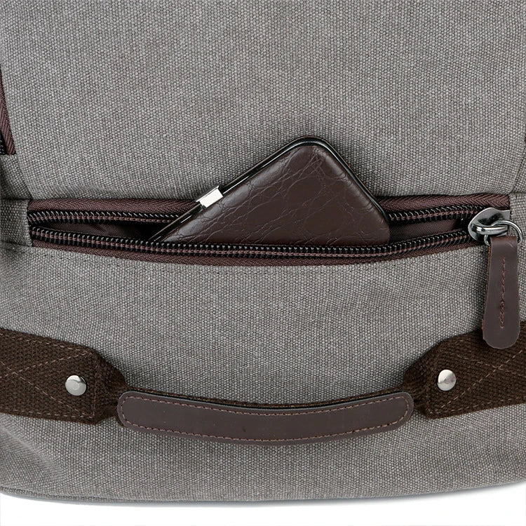 A classic messenger bag made of durable canvas with genuine leather trim, offering style and function for the modern British gentleman