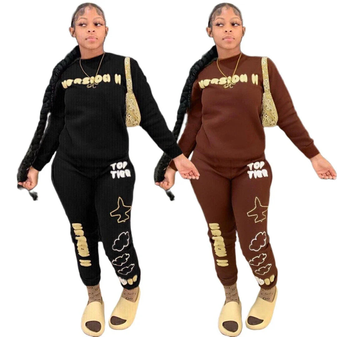 Stylish two-piece casual sports outfit for women, featuring a relaxed top and comfortable trousers in black and brown colors.