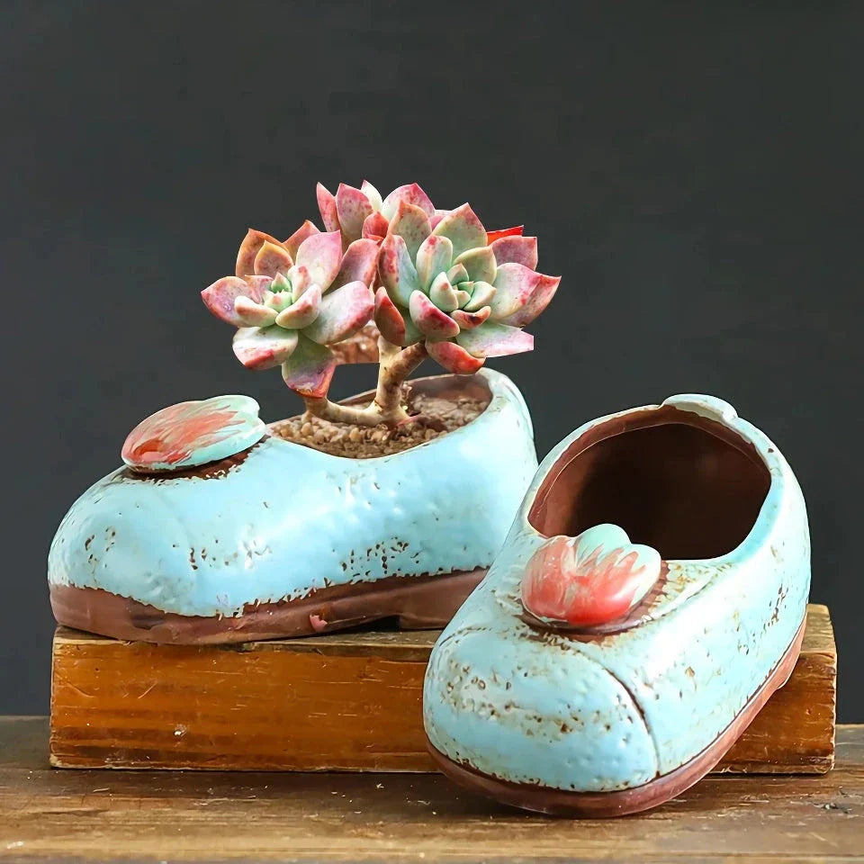 Charming ceramic boot-shaped vase with a glazed finish, perfect for displaying succulents and flowers in your home or garden