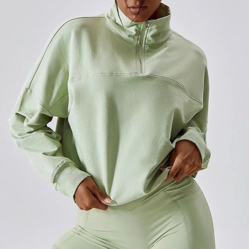 A cosy, oversized cotton pullover with a stylish zipper accent, perfect for casual autumn and winter wear.
