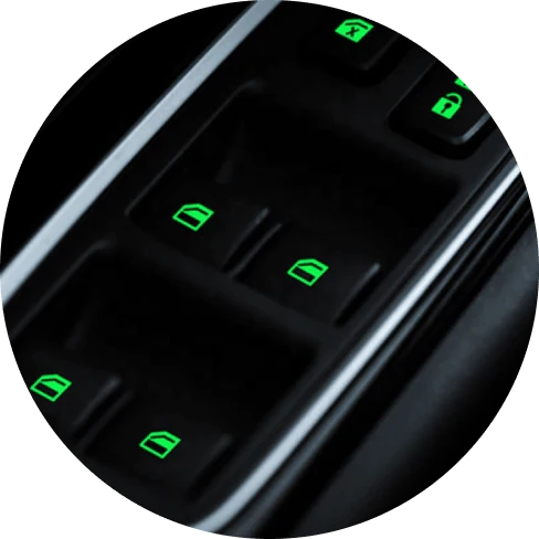 Fluorescent car button stickers emitting a bright green glow for easy visibility in the dark