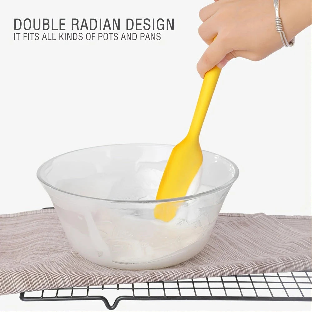 A set of two high-quality silicone spatulas in brown and yellow colours, designed for versatile cooking and baking tasks.