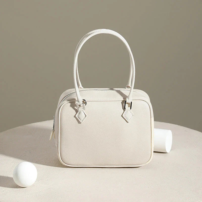 Elegant leather mini shoulder bag in a variety of colours, featuring a compact and versatile design for the stylish British woman.