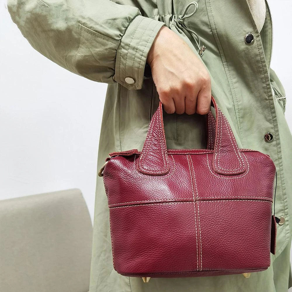 Premium leather shoulder bag for women in red, blue, and black colours with spacious interior and comfortable strap
