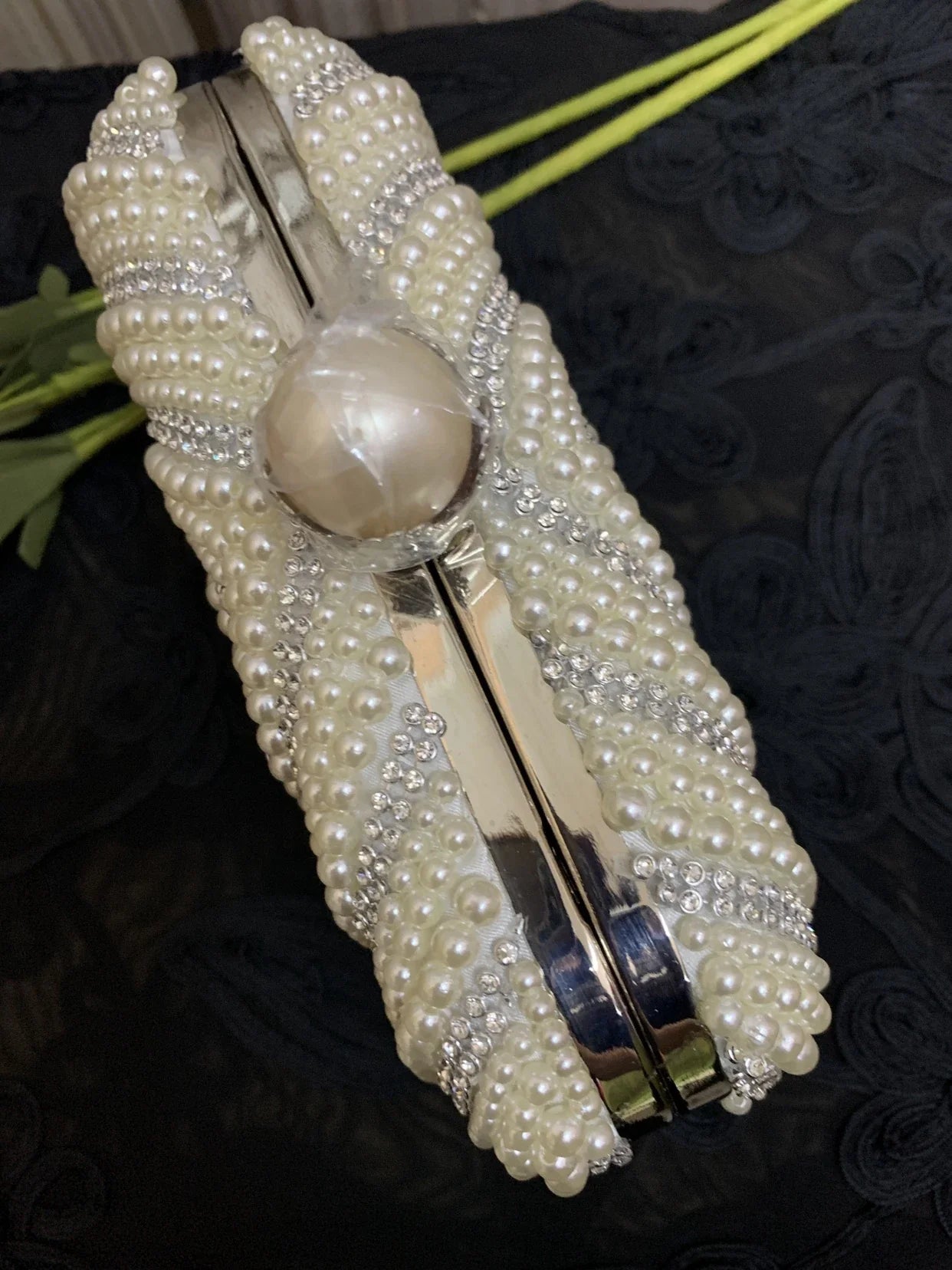 Sophisticated gold cheongsam handbag with pearlescent charm, a compact and stylish accessory for formal and casual occasions