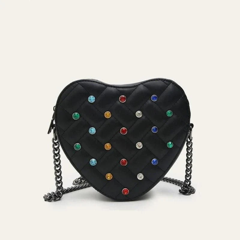 A stylish heart-shaped vegan leather crossbody bag with colourful rhinestone detailing, a versatile and fashionable accessory.
