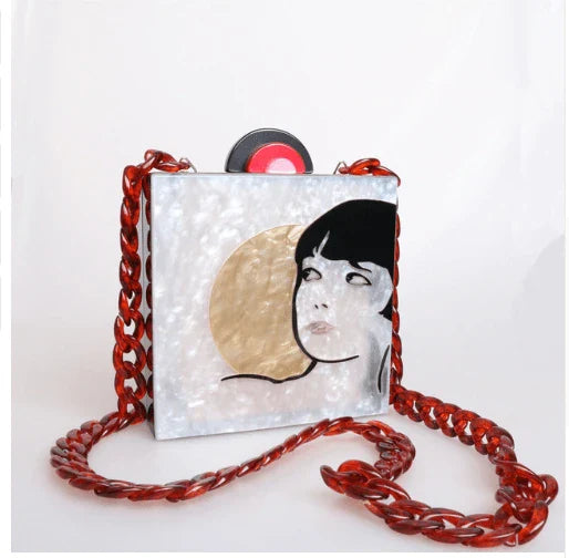 Antique hand-stitched acrylic crossbody bag in a vintage style with a yellow chain strap, perfect for evening events or everyday use.