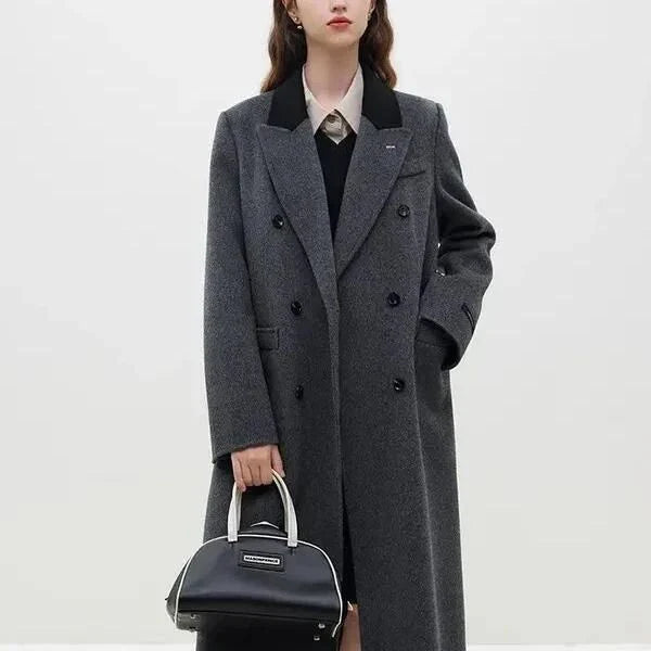 A sophisticated and stylish dark grey woollen coat for women, designed with a timeless double-breasted closure and notched collar.
