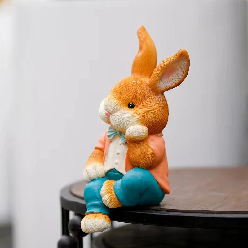 A detailed and lifelike resin statue of a thoughtfully sitting rabbit, adding a whimsical touch to any home or garden decor.